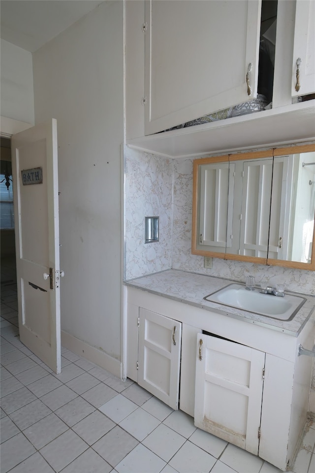 kitchen with light tile patterned floors, white cabinets, and tasteful backsplash