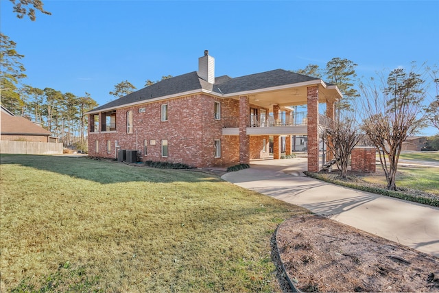 back of property with a balcony and a yard