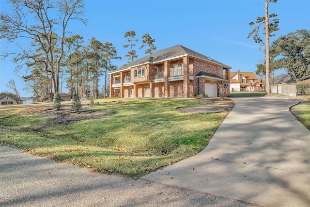 view of front of property featuring a garage and a front yard