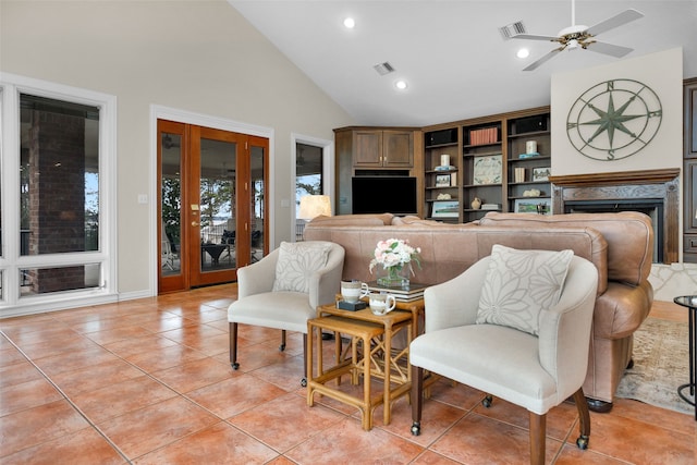 living area with ceiling fan, light tile patterned floors, and high vaulted ceiling