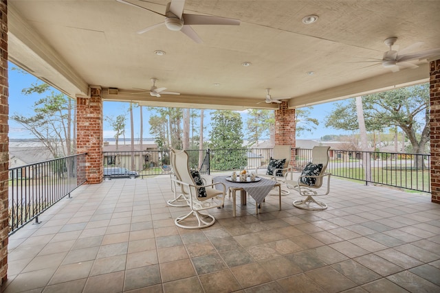 view of patio with ceiling fan and an outdoor fire pit