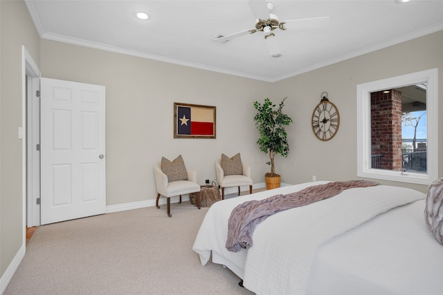 carpeted bedroom with ornamental molding and ceiling fan