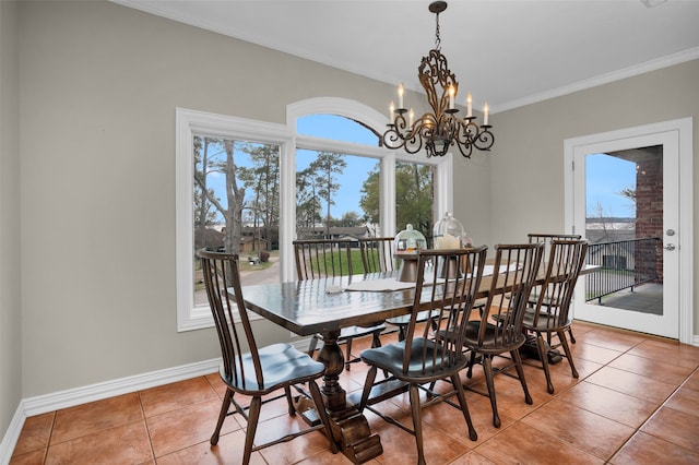 dining area featuring tile patterned flooring, a wealth of natural light, a chandelier, and crown molding