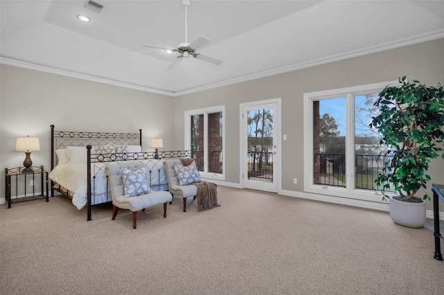 carpeted bedroom featuring a tray ceiling, access to exterior, ceiling fan, and crown molding