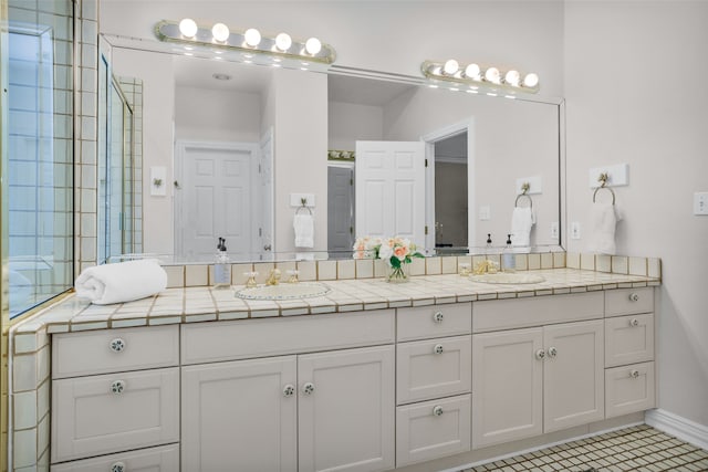 bathroom with tile patterned flooring and vanity