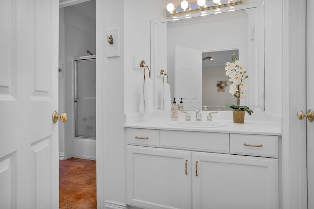 bathroom featuring shower / bath combination with glass door, tile patterned floors, and vanity