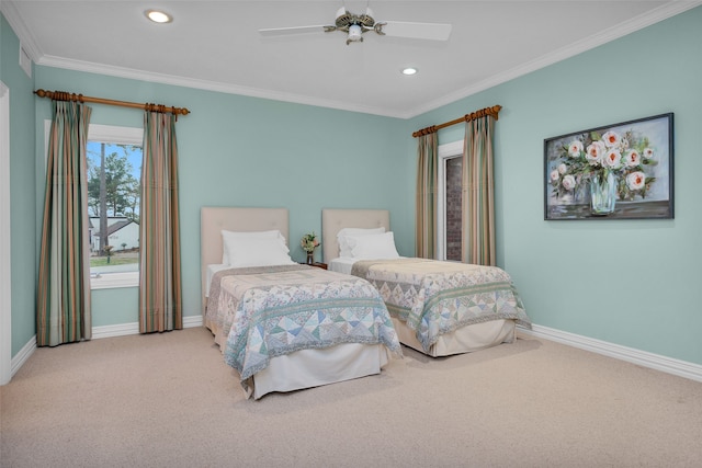 bedroom with crown molding, ceiling fan, and carpet floors