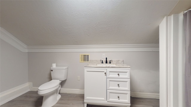 bathroom featuring a textured ceiling, toilet, vanity, hardwood / wood-style flooring, and crown molding