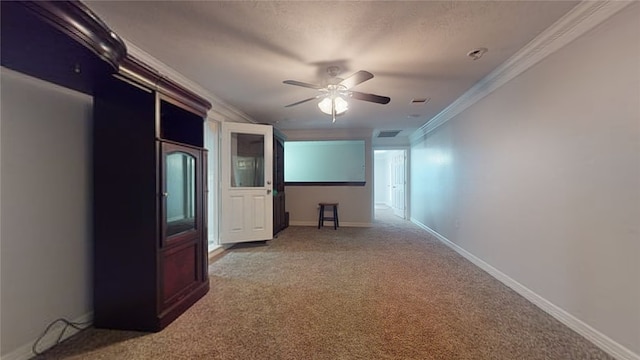 empty room with light colored carpet, ceiling fan, and crown molding