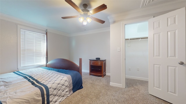 carpeted bedroom with a closet, ornamental molding, and ceiling fan