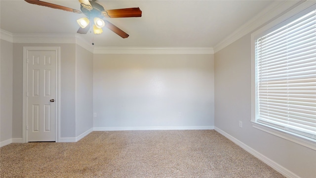 carpeted empty room featuring ceiling fan and crown molding