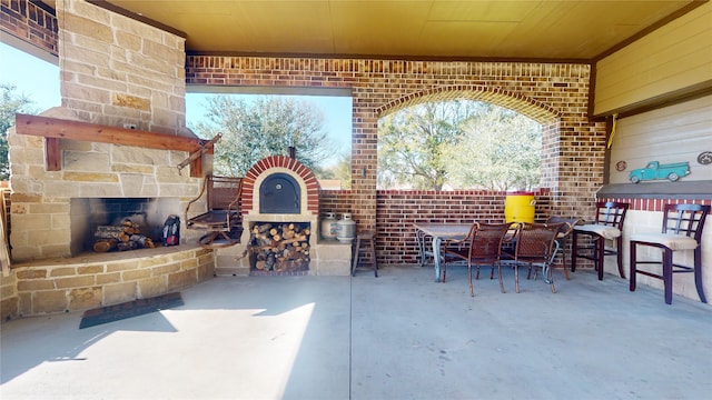 view of patio / terrace featuring an outdoor stone fireplace