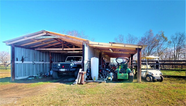 view of outdoor structure featuring a carport and a lawn