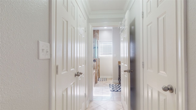 corridor with ornamental molding and light tile floors