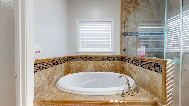 bathroom with a relaxing tiled bath