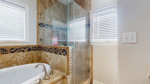 bathroom featuring shower with separate bathtub