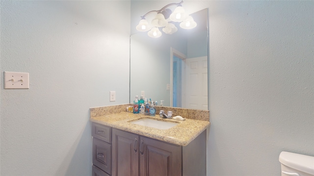 bathroom featuring toilet and vanity