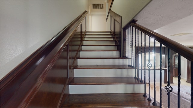 staircase with dark wood-type flooring