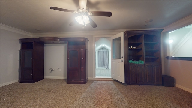 interior space featuring ceiling fan, crown molding, and carpet floors