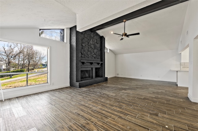 unfurnished living room featuring a textured ceiling, lofted ceiling, and hardwood / wood-style flooring