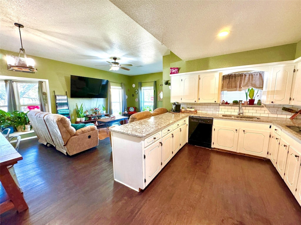 kitchen featuring sink, dishwasher, kitchen peninsula, and dark wood-type flooring