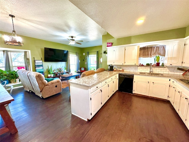 kitchen featuring sink, dishwasher, kitchen peninsula, and dark wood-type flooring