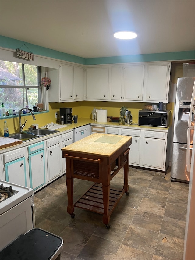 kitchen featuring white cabinets, appliances with stainless steel finishes, and sink