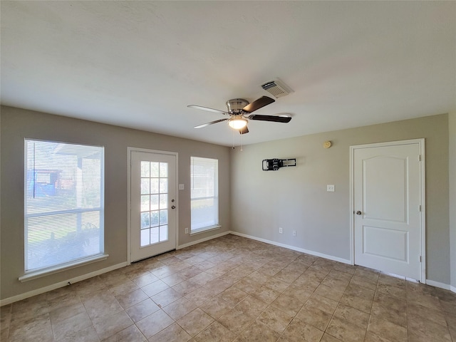 unfurnished room with light tile floors and ceiling fan