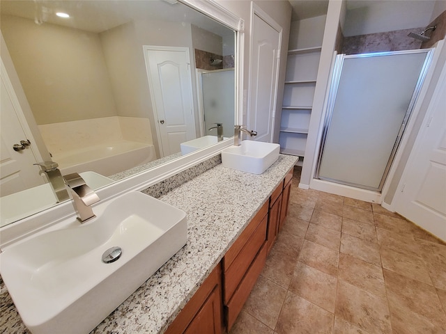 bathroom featuring dual sinks, tile floors, large vanity, and independent shower and bath