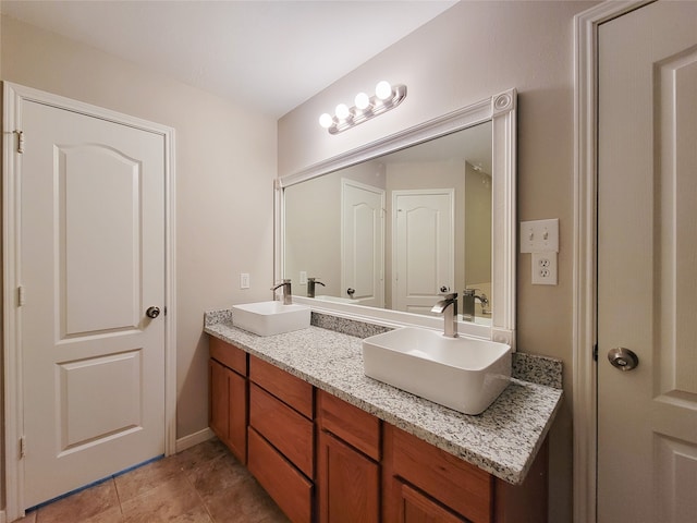 bathroom featuring dual vanity and tile floors