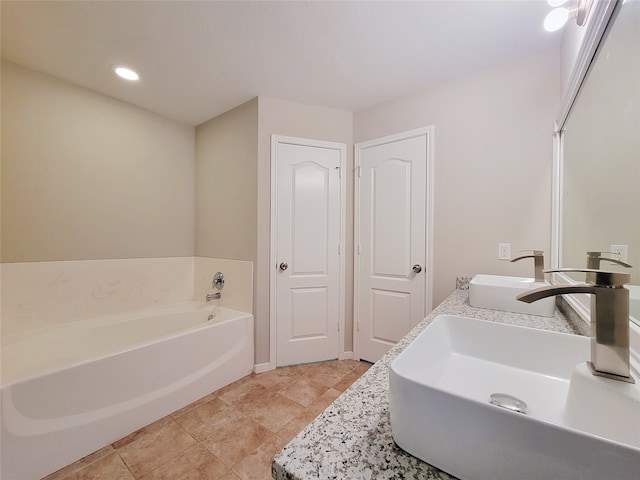 bathroom featuring a bath to relax in, tile flooring, and vanity