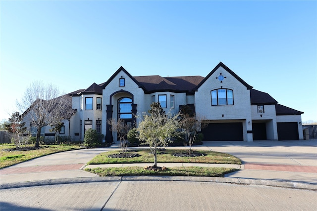 french provincial home featuring a garage and driveway