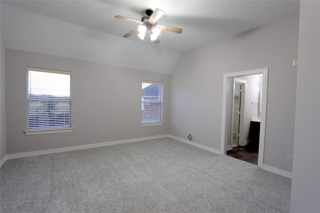 carpeted empty room with ceiling fan and vaulted ceiling