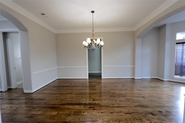 spare room with an inviting chandelier, dark hardwood / wood-style flooring, and ornamental molding