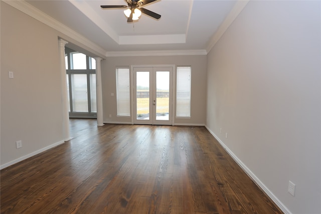 unfurnished room with a tray ceiling, dark hardwood / wood-style flooring, french doors, and ceiling fan