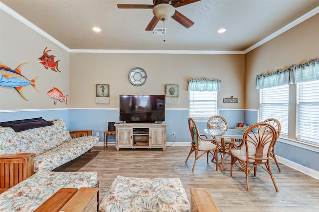 dining room featuring ceiling fan, crown molding, and light hardwood / wood-style floors