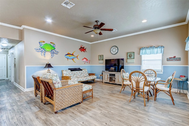 living room with ceiling fan, crown molding, and light hardwood / wood-style flooring