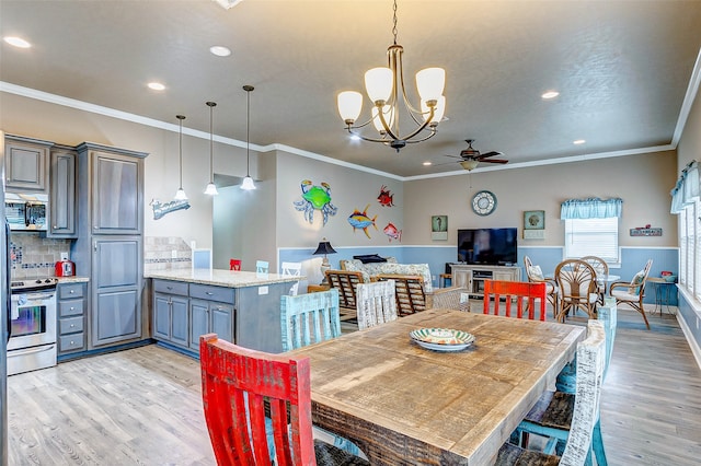 dining room featuring ornamental molding, light wood-type flooring, and ceiling fan with notable chandelier