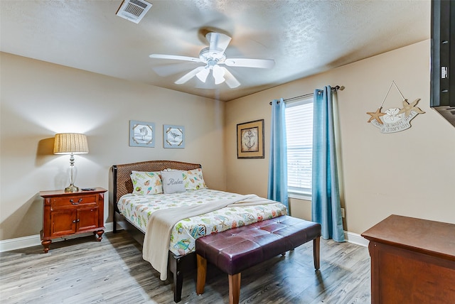 bedroom with ceiling fan and light wood-type flooring