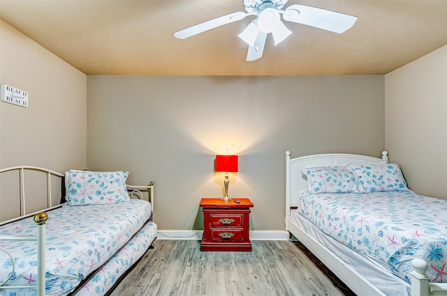 bedroom with ceiling fan and dark wood-type flooring