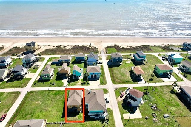 birds eye view of property featuring a view of the beach and a water view