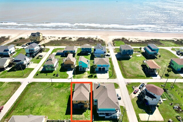 drone / aerial view with a water view and a beach view