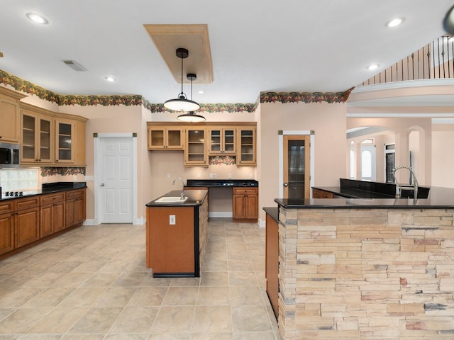 kitchen featuring hanging light fixtures, gas stovetop, light tile flooring, vaulted ceiling, and a kitchen island