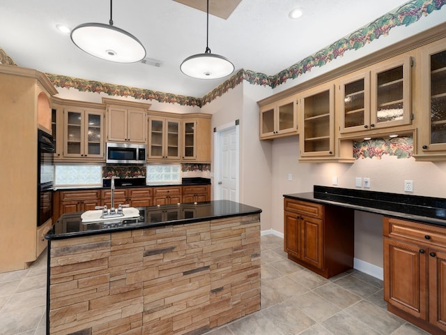 kitchen with light tile floors, black double oven, backsplash, hanging light fixtures, and sink