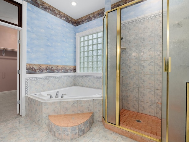 bathroom with tile flooring and separate shower and tub