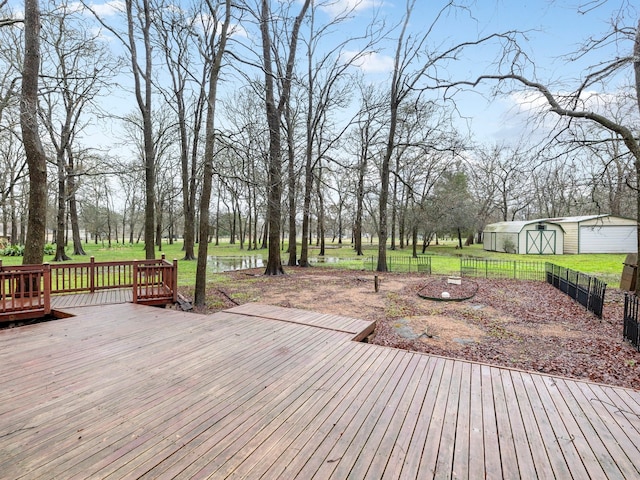 wooden deck featuring a storage unit and a yard