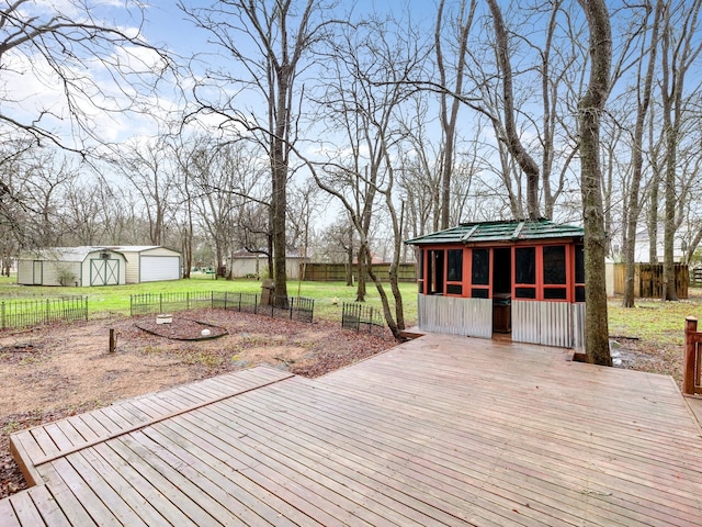 wooden deck with an outdoor structure and a lawn