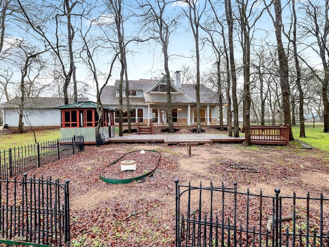 back of house with a wooden deck and an outdoor structure