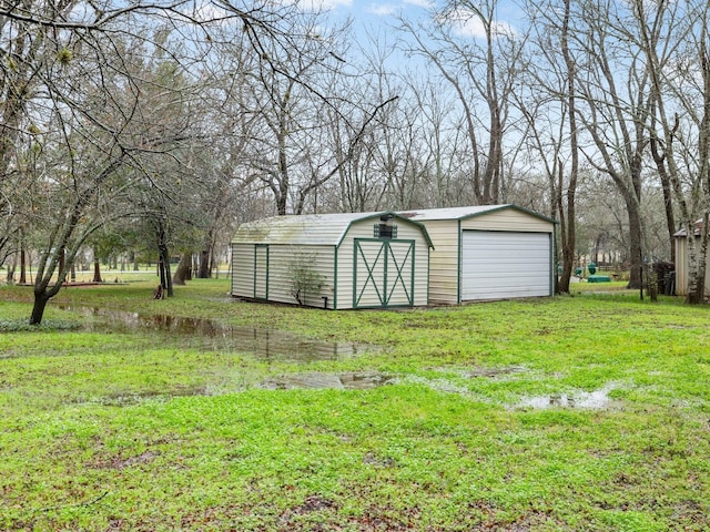 view of shed / structure with a lawn and a garage