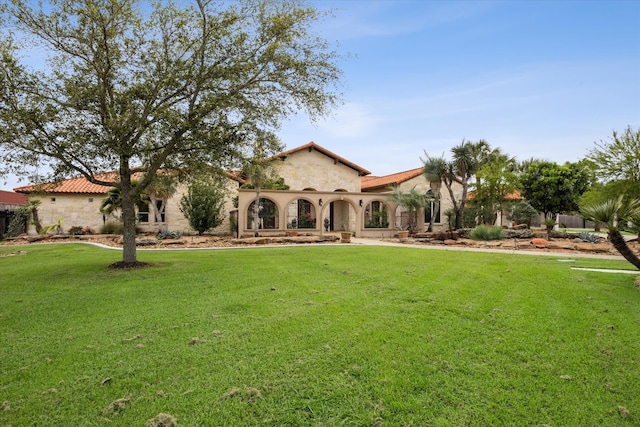 mediterranean / spanish-style home with a front yard